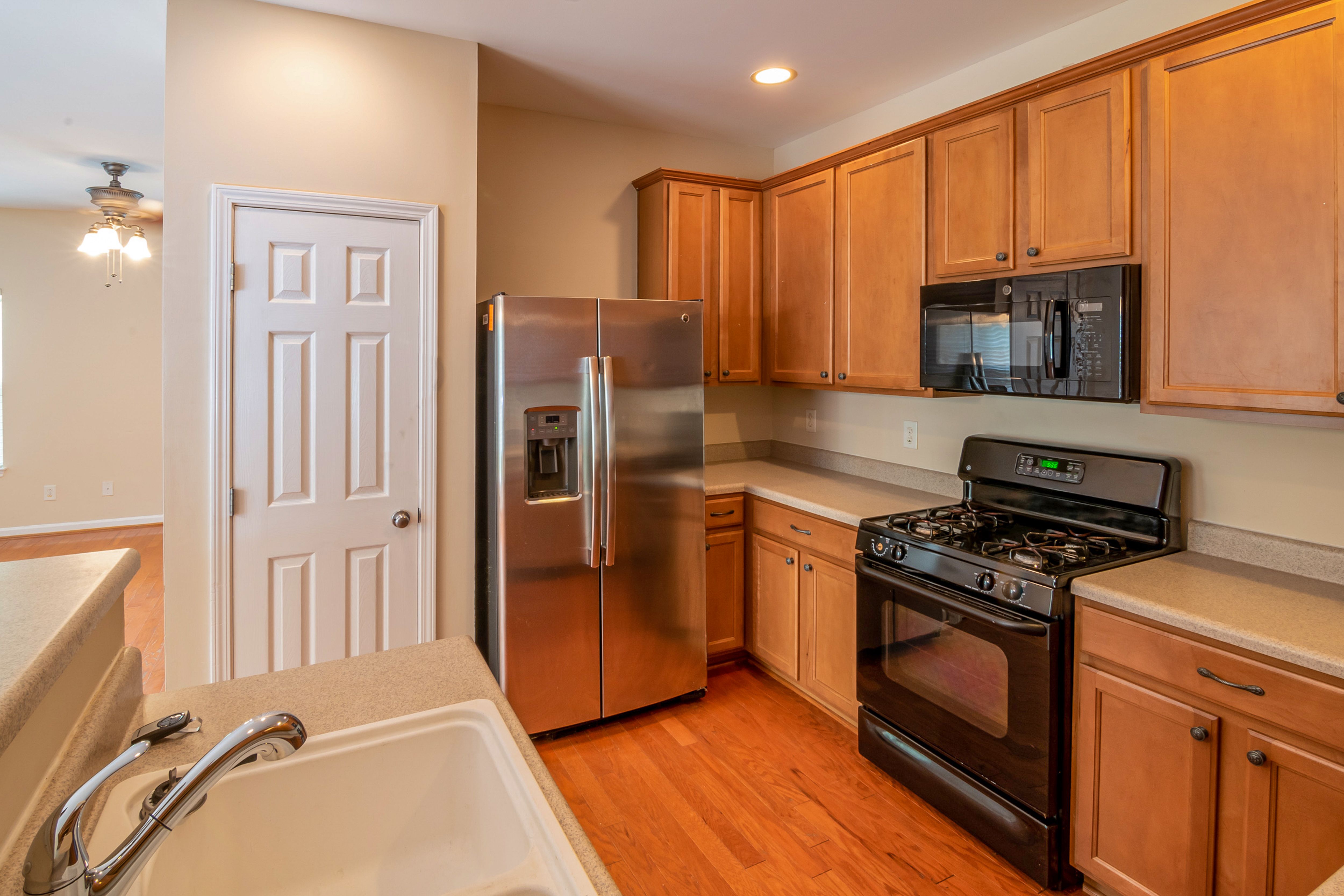 Kitchen cabinets open showing dishes and glasses ready to be packed for a move in Fredericksburg VA