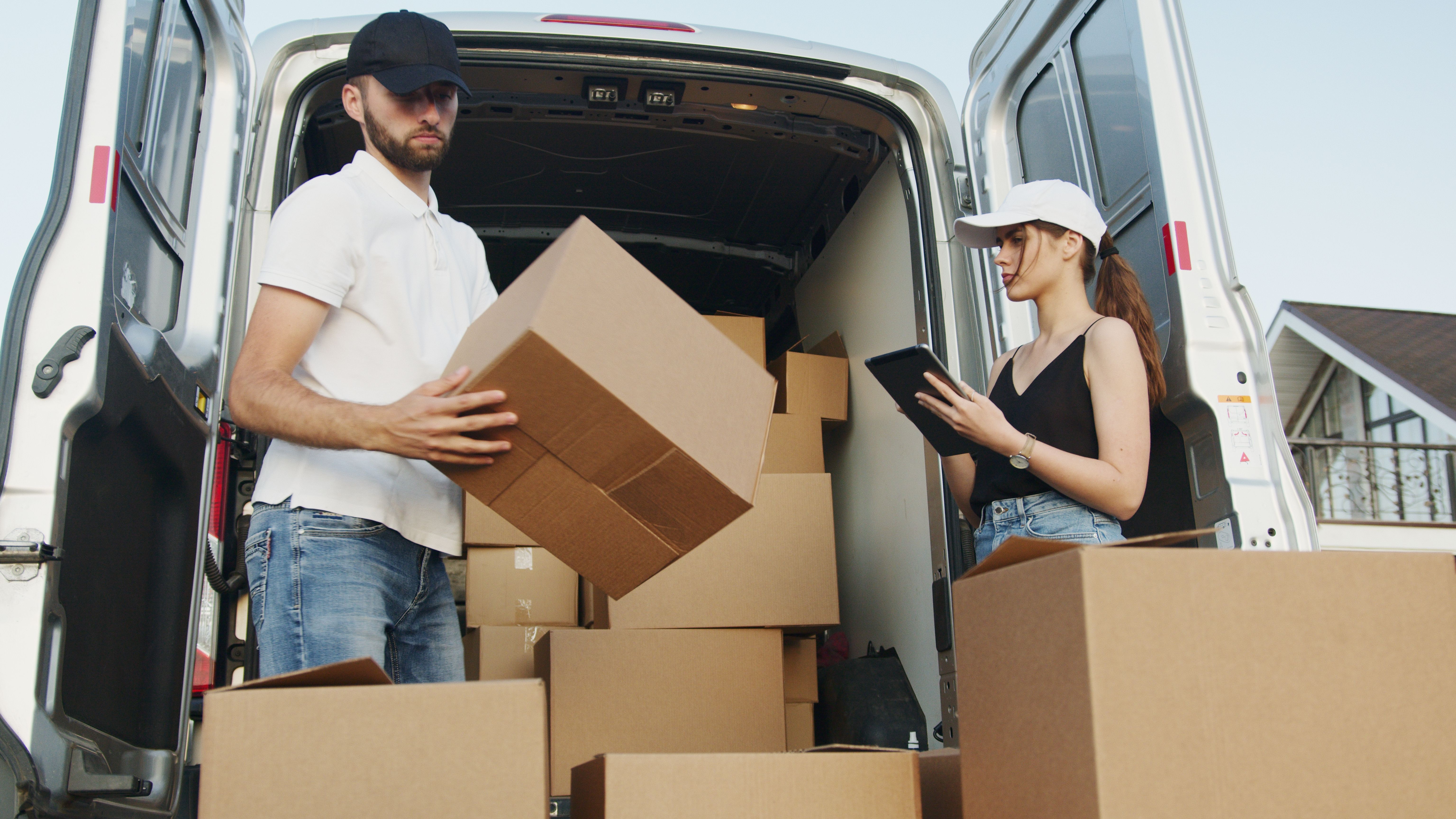 Professional movers with packed moving boxes